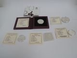 a silver coin in a wooden box with a lot of cards