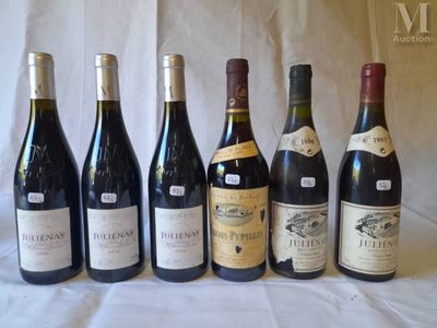 several bottles of wine are lined up on a table