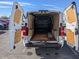 a white van with its doors open in a parking lot
