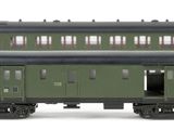 three green train cars sitting next to each other on a white surface