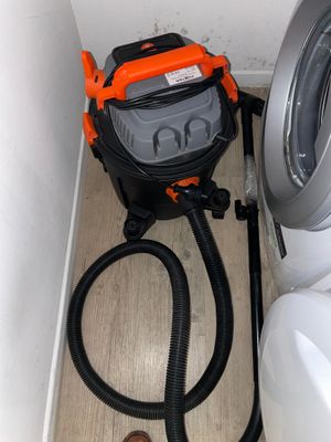 a washing machine and a dryer in the corner of a room