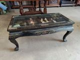 a coffee table with a glass top sitting in a room