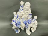 a figurine of a boy and a girl sitting on a bench