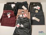 several pairs of men ' s jeans are lined up on a table