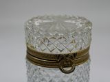 a glass jar with a gold ring on top of it