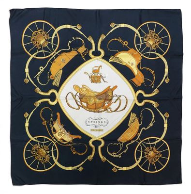 a square scarf with a gold and black design on it