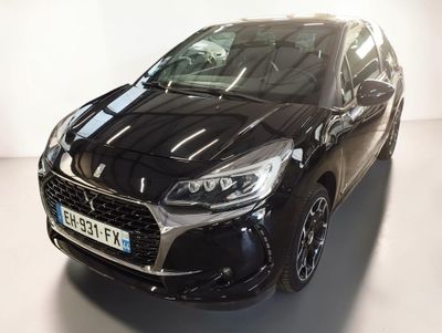 the front view of a black car parked in a white room