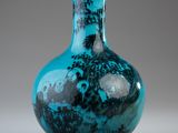 a blue glass vase with a picture of a castle on it