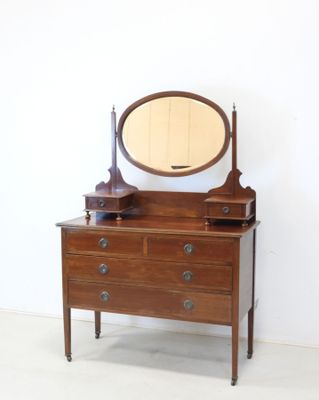 a dresser with a mirror and a lamp on it