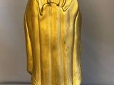 gold statue of a person with a blue base