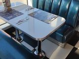 a table and chairs in a restaurant with a checkered floor