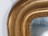a gold frame with a mirror in it on the wall