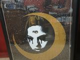 framed poster of a woman with a crescent on her face