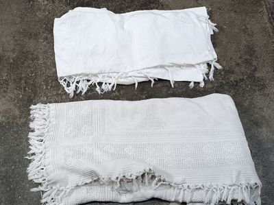two white towels on the ground next to each other