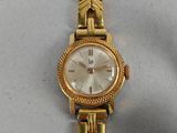 an image of a woman ' s wrist watch on a white surface