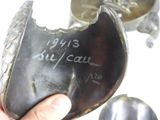 a person holding a metal object with a writing on it