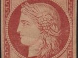 a red and black stamp with a woman ' s head on it