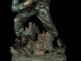 statue of a man with a gun on a base with a black background