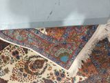 a cat that is sitting on a rug on the floor