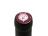 a close up of a bottle of wine on a white surface