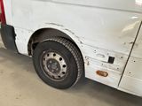 a white van that has been vandalized and is parked in a garage