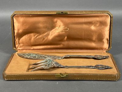 an antique silverware set in a case with a spoon and fork in it