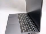 a silver laptop with a black keyboard on a white surface