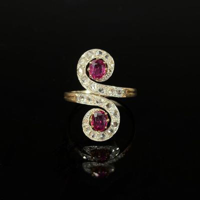 a yellow gold ring with a pink tourmaline and white diamonds