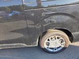 a black van with a flat tire on the street