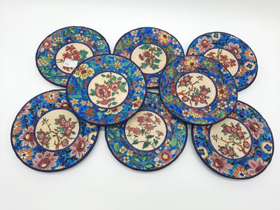 six blue and pink plates with floral designs on them on a white surface