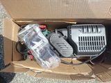 a box that has a compressor in it on the ground