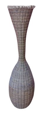 a wicker vase that is sitting on a white surface
