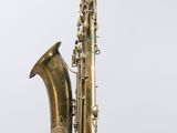 an old brass saxophone with a white background
