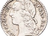 a silver coin with a woman ' s head on it