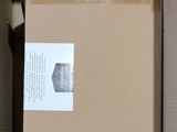 a cardboard box with a sticker on it sitting in a box