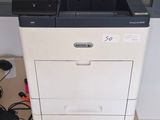 a printer sitting on top of a table with a laptop on it