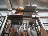 many rolls of paper on a rack in a warehouse