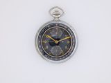 an old pocket watch on a white surface with a yellow second hand