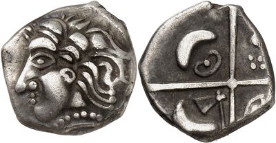a close up of a coin with a face on it