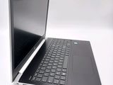a laptop that is open on a white surface