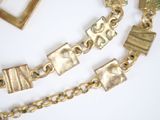 a picture of a gold necklace and a gold bracelet
