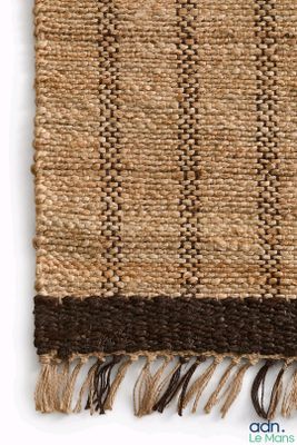 a close up of a woven rug on a white surface