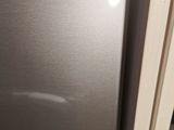 a stainless steel refrigerator in the corner of a kitchen