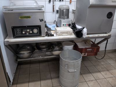 a kitchen with a lot of pots and pans on the counter