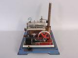 a small model of a steam engine on a blue stand