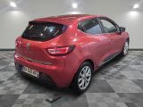 the rear end of a red car in a room with a checkered floor