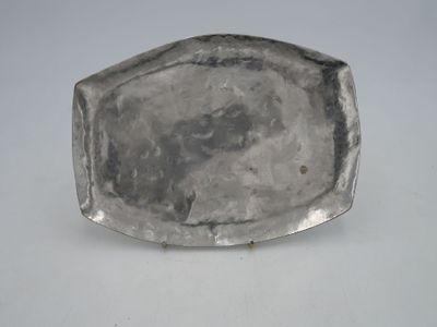 an antique silver plate on a white table with a white background