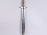 a close up of a knife on a white surface