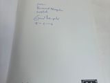 a book with a handwritten note on it sitting on a table