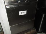 an image of a kitchen with a stove and a trash can